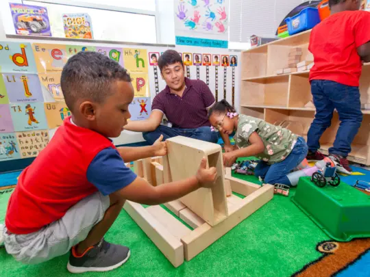 child-care-provider-and-children-playing