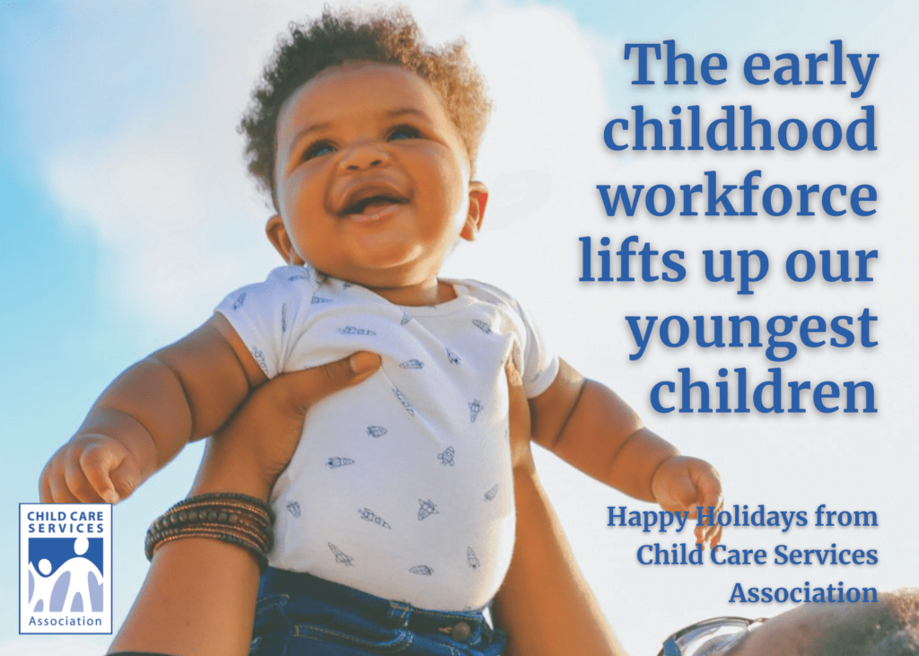 CCSA Holiday card with a person lifting a Black baby into a blue sky background