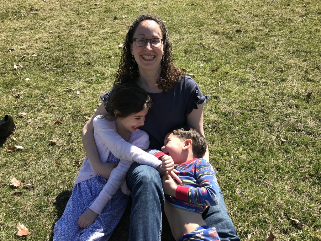 A mother and her two children playing outside