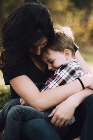 woman hugging young boy
