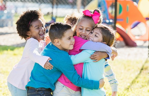 kids hugging on playground